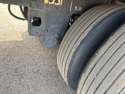 Trailer wheel and suspension area of a 2022 Utility 3000R reefer trailer showing dual tires and undercarriage components.