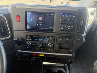 Dashboard of a 2026 Mack PR64T76H showing a center touchscreen, climate controls, switches, and instrument panel.