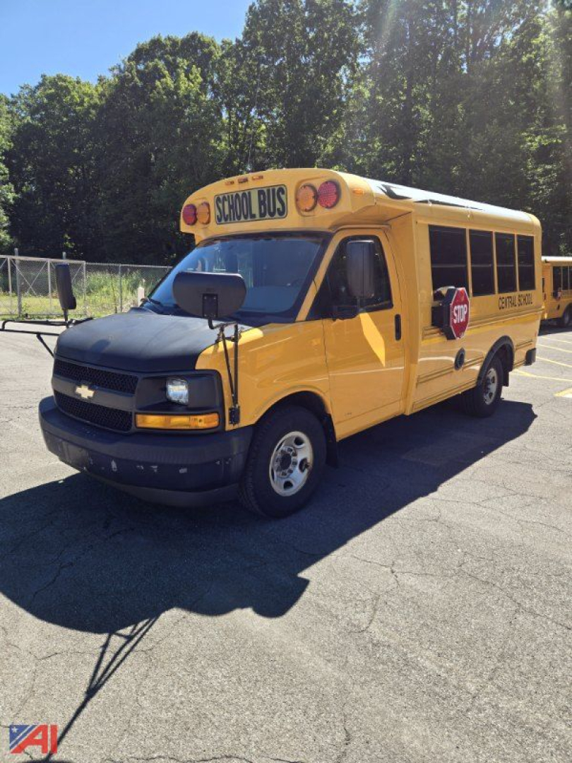 School bus front-left view: yellow 2017 Chevrolet Express G3500 mini school bus with STOP sign and SCHOOL BUS signage.