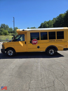 School bus side view showing yellow Express G3500 with stop sign and Central School lettering.