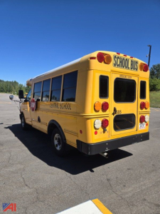 Back-right view of a yellow school bus labeled CENTRAL SCHOOL with 'SCHOOL BUS' sign on rear, 2017 Chevrolet Express G3500 Mini School Bus, black bumper, red taillights.