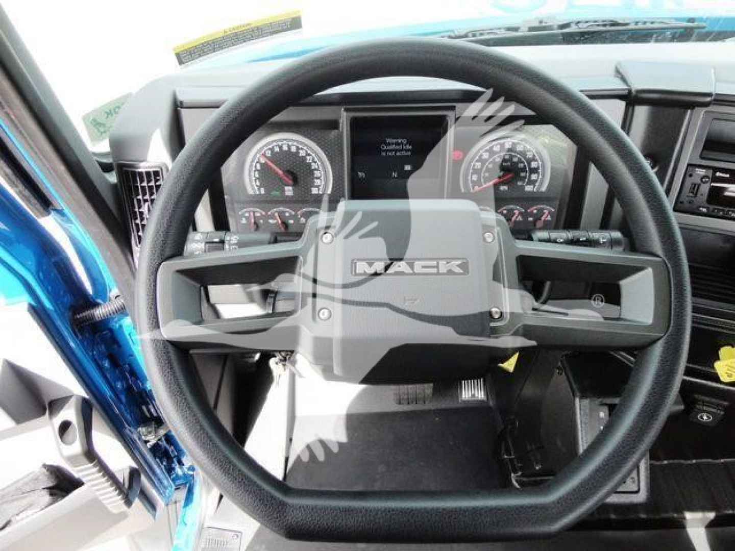 Dashboard view of a 2027 Mack MD6 cab interior with steering wheel centered, instrument cluster, and controls visible.