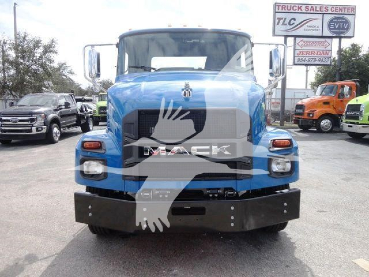 Blue 2027 Mack MD6 truck front view with large grille, bumper, and side mirrors in a dealership lot.
