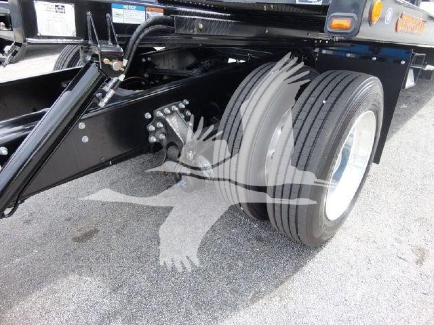 truck rear axle and dual rear tires on a Mack MD6 rollback chassis showing suspension and frame components