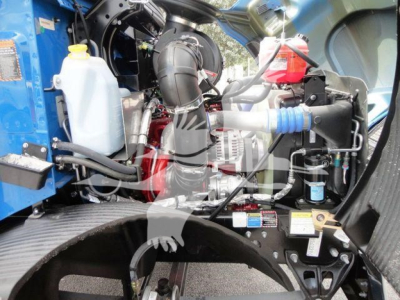Mack MD6 engine bay and components visible with coolant reservoir, hoses, and wiring harness.