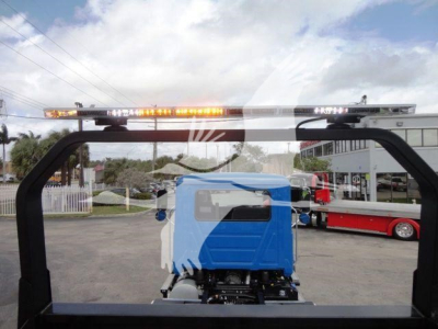 Mack MD6 rollback truck cab with rooftop amber warning light bar visible through rear window