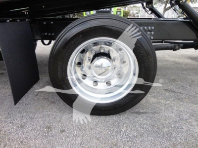 Mack MD6 truck wheel and chrome hubcap with black tire, undercarriage view