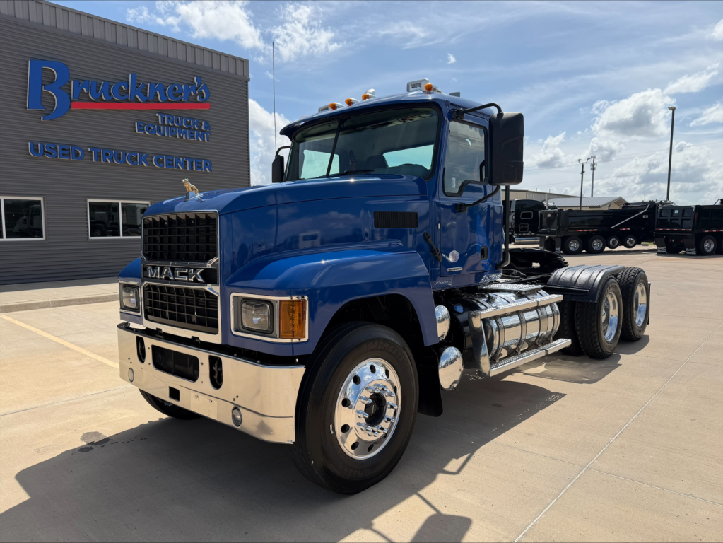 Mack PI64T truck in blue, side view, at a used truck center lot.