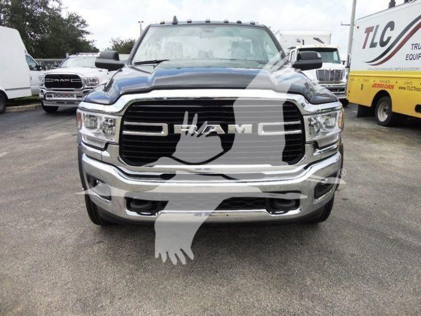 Front view of a black 2024 Ram 4500 SLT pickup truck with chrome grille and RAM badge, showroom setting.
