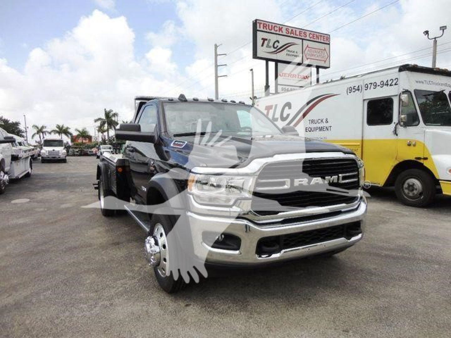 Ram 4500 SLT pickup truck in a dealership lot with a winch category tag visible, front grille and chrome bumper, other vehicles in background.