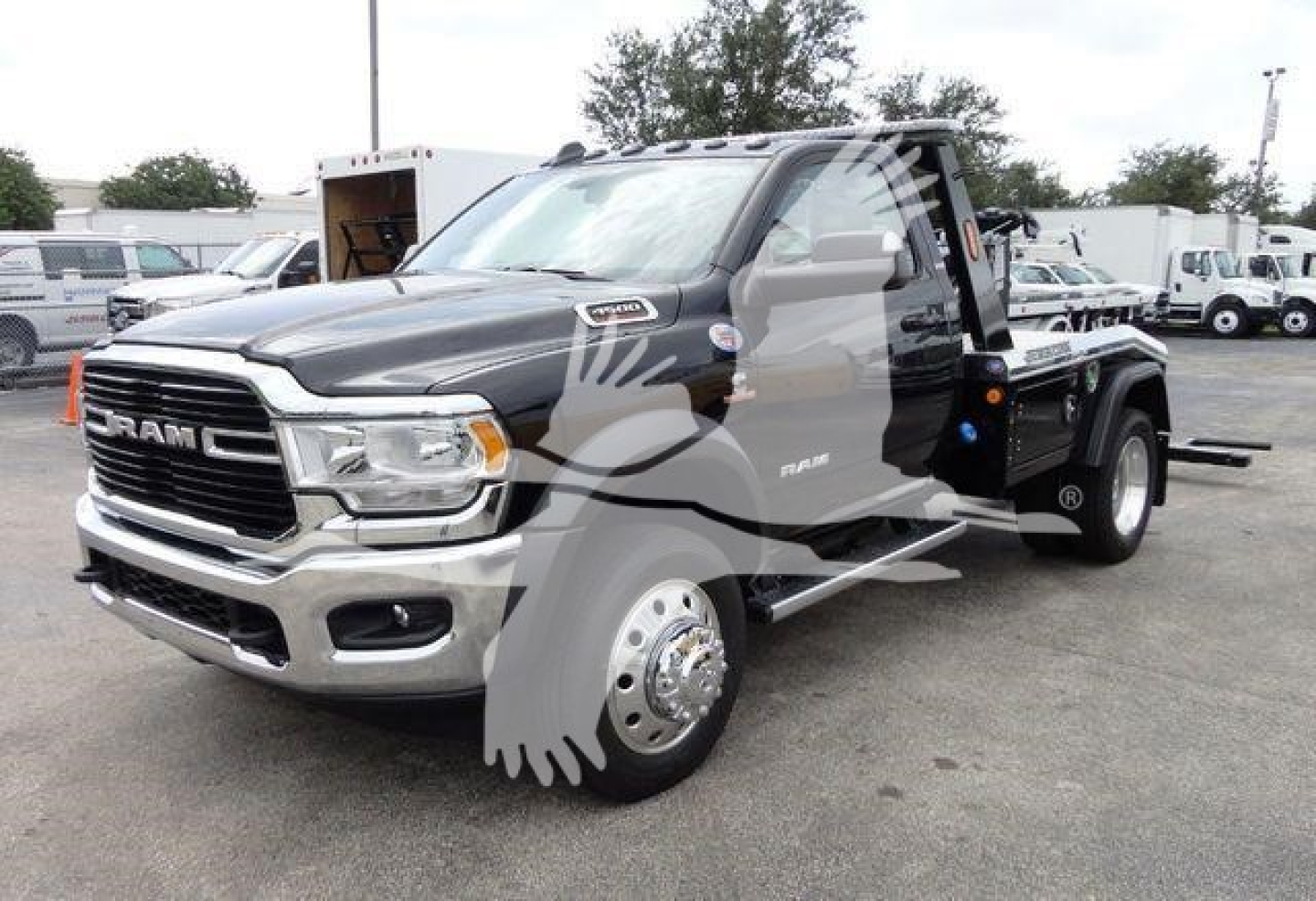 Ram 4500 SLT pickup truck in a dealership lot with a front chrome grille and black body.