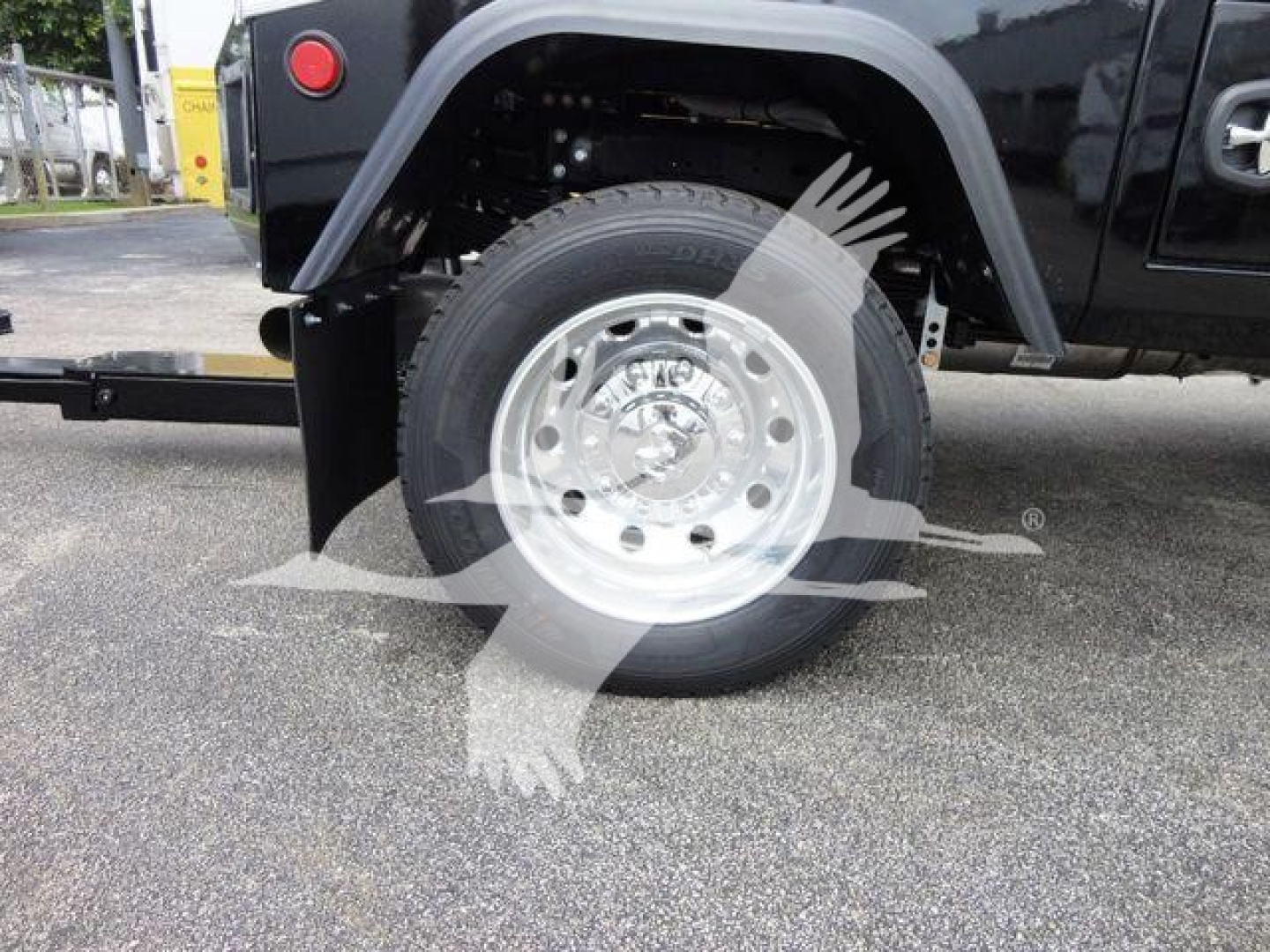 Truck wheel and fender viewed from side showing steel wheel, tire, and rear portion of Ram 4500 SLT; winch category label visible.