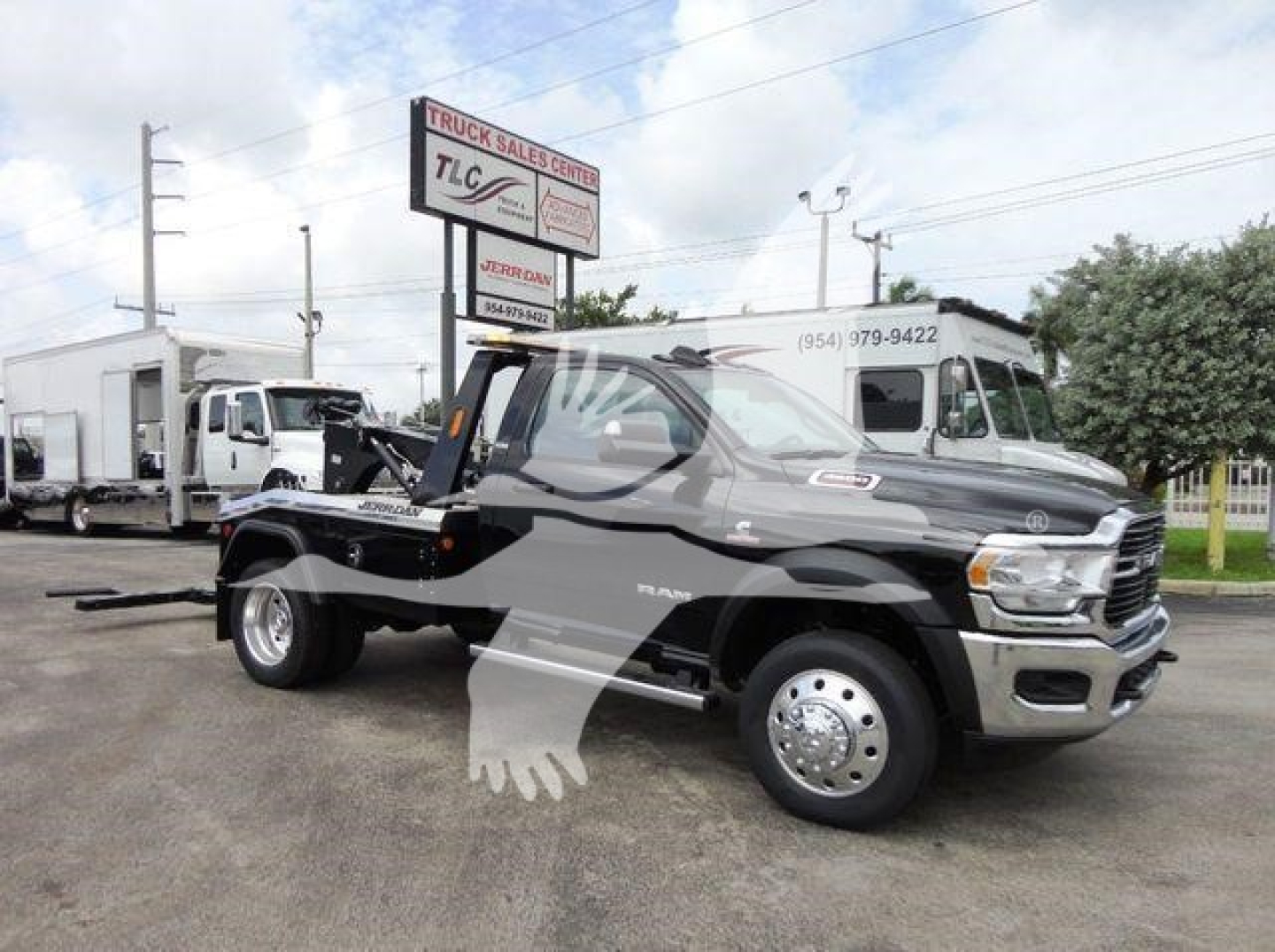 Ram 4500 SLT tow truck configuration showing black body, chrome bumper, warning decal, winch mounting on bed, front grille, dual rear wheels.