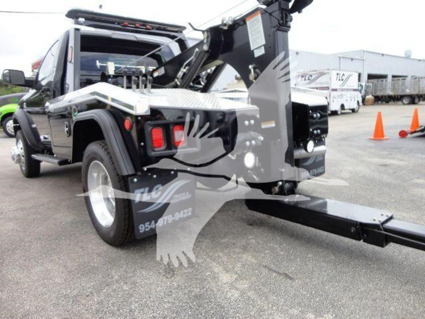 Ram 4500 SLT w/ winch setup showing hitch, cable, and upright hoist with black and silver color scheme; some equipment labels visible on the side panels.