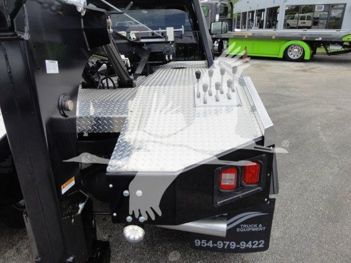 Truck bed corner with diamond plate platform and vertical pins, rear taillights, and chrome stake pockets on a Ram 4500 SLT winch truck, stock J68872.