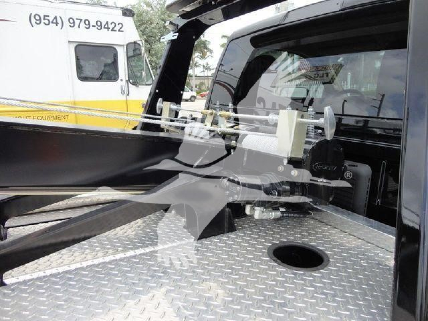 Ram 4500 pickup bed with winch system and diamond plate surface in truck bed area.
