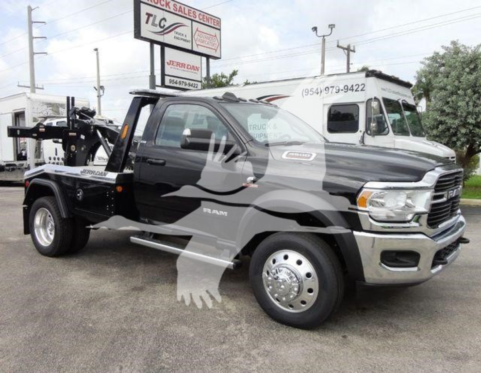 Ram 4500 SLT tow truck/flatbed in a dealership lot showing front and side view with tow equipment and stock number signage.