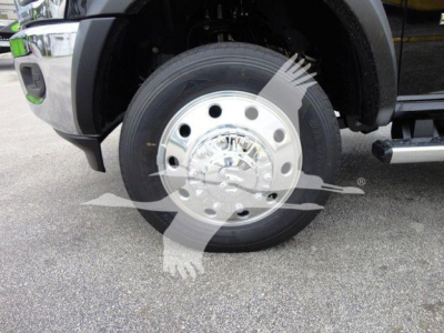 Ram 4500 truck front wheel showing polished steel hubcap and black tire, partial fender and side step visible.