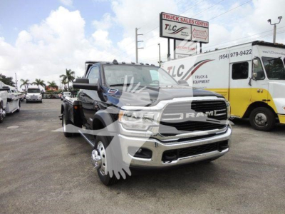 Ram 4500 SLT pickup truck in a dealership lot with a winch category tag visible, front grille and chrome bumper, other vehicles in background.