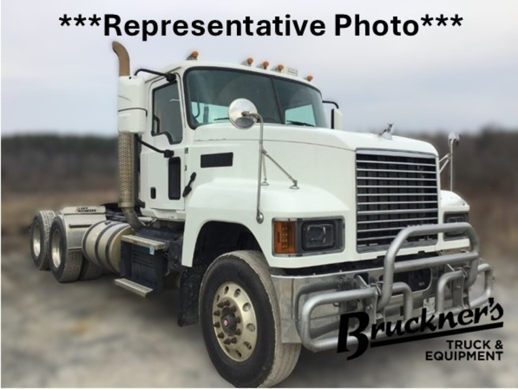 Truck cab with bulldog-style front bumper and grille guard, white Mack PI64T daycab, dual rear axles, side mirrors, and 'Representative Photo' text overlay.