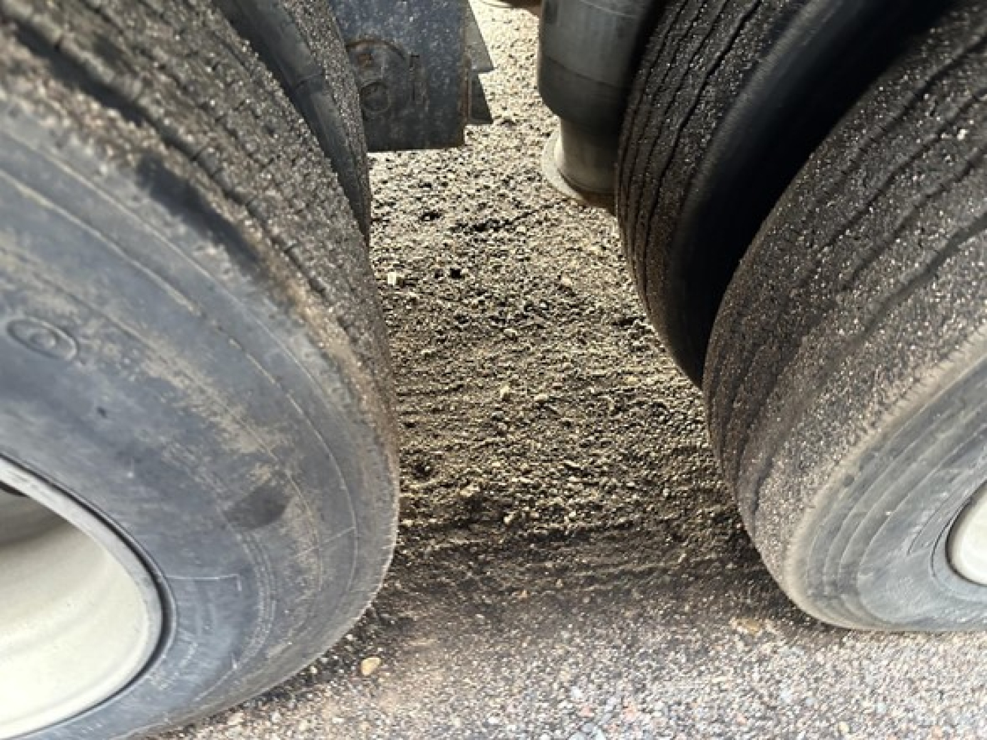 Trailer axle wheels in view with hydraulic tail system label not visible. Close-up of dual rear tires on a 2017 Trail King 40 Ton hydraulic tail trailer.