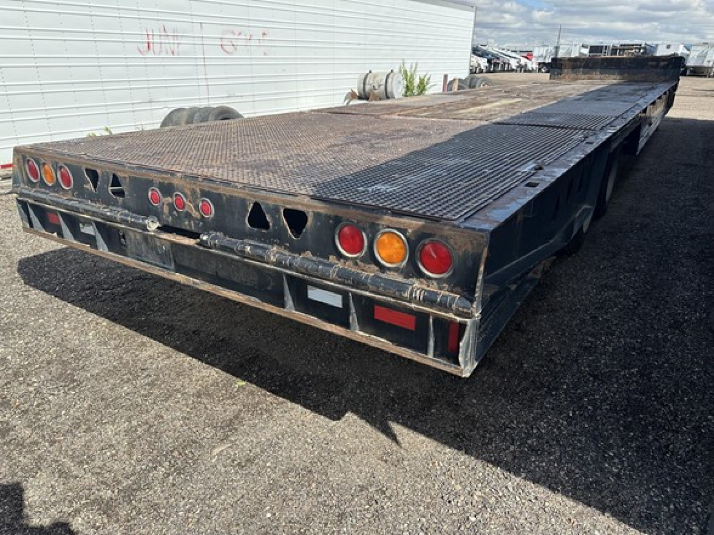 Low-angle rear view of a 2017 Trail King 40 Ton hydraulic tail trailer showing rear lights and metal deck.