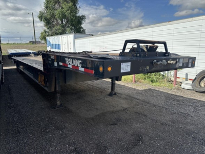 Trail King 40 Ton hydraulic tail trailer in view from rear-left side showing flatbed with dual axles, Trail King logo, rear ramps, and hitch.