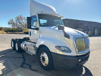 International LT625 truck cab view showing front grille, left side, and dual rear axles with white cab.