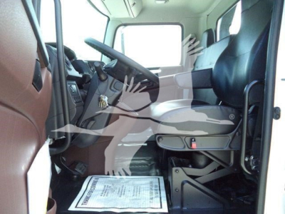 Interior of a new 2026 Hino L6 cab: front seats, dashboard, steering wheel, and driver area visible.