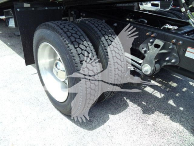 Truck rear dual wheels and suspension components visible underFRAME near axle