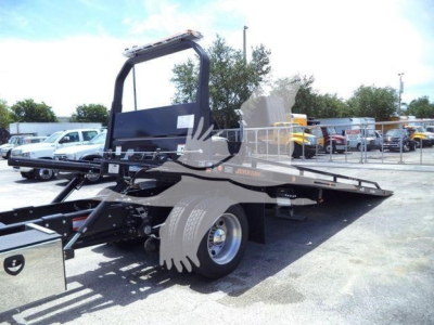 Hino L6 rollback truck chassis and flatbed with hydraulic ramp, side view showing wheel and bed structure.
