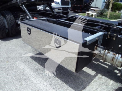 Hino L6 truck chassis side view showing a metallic toolbox mounted under the frame with a silver surface and black trim.