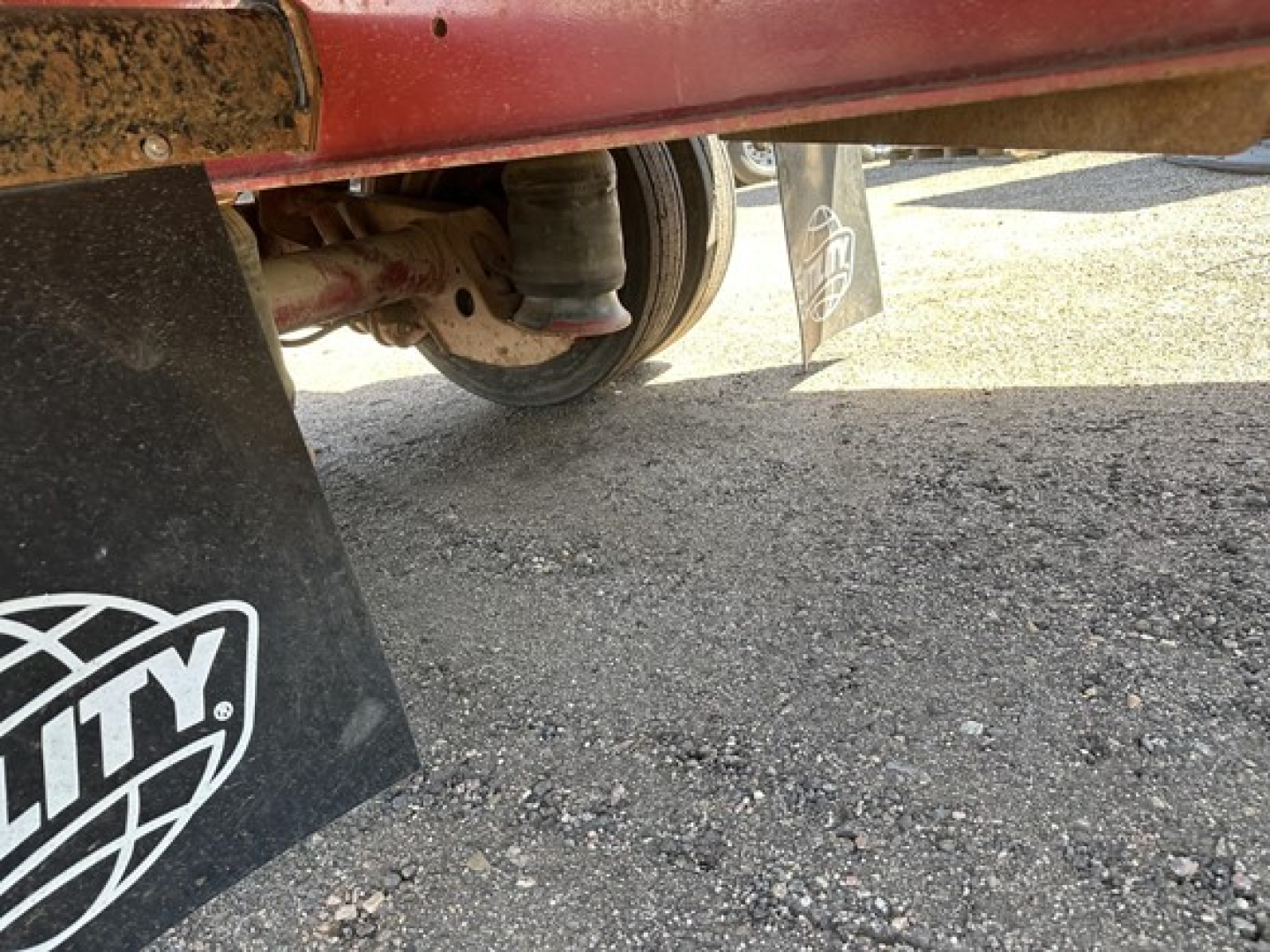 Fontaine spread air combo drop deck trailer undercarriage with wheel and mudflap visible.
