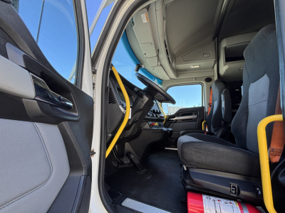 Kenworth T680 truck cab interior showing driver's seat, steering wheel, and dashboard area.