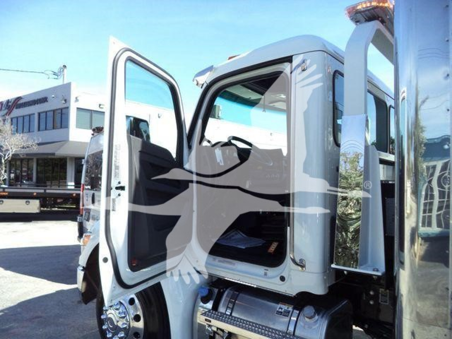 Kenworth T280 rollback truck with driver and passenger doors open showing cab interior and steps.