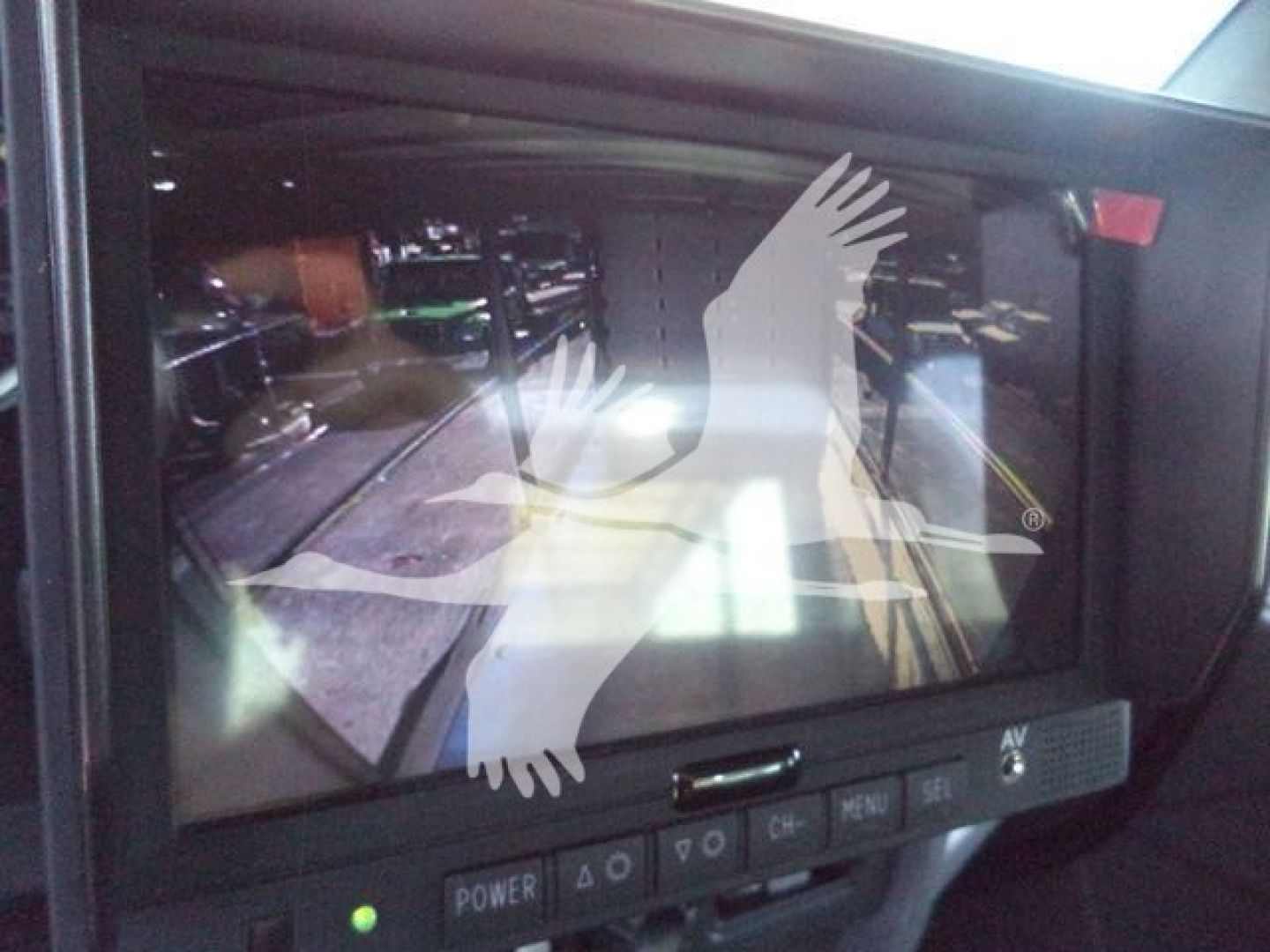 Kenworth truck dash display showing a touchscreen monitor with reflection and overlay; buttons labeled POWER, 4Q, MENU, VOLUME, etc.