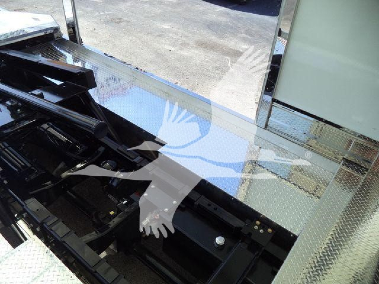 Kenworth T280 rollback truck interior/step area showing metal diamond plate surface and chassis components.