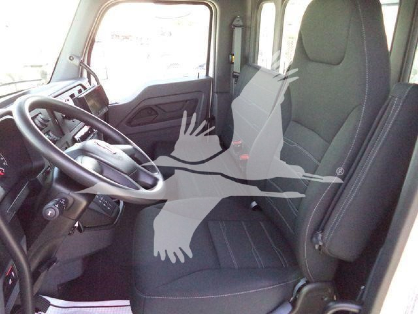 Kenworth T280 truck cab interior showing driver seat and steering wheel with dashboard and door panel.