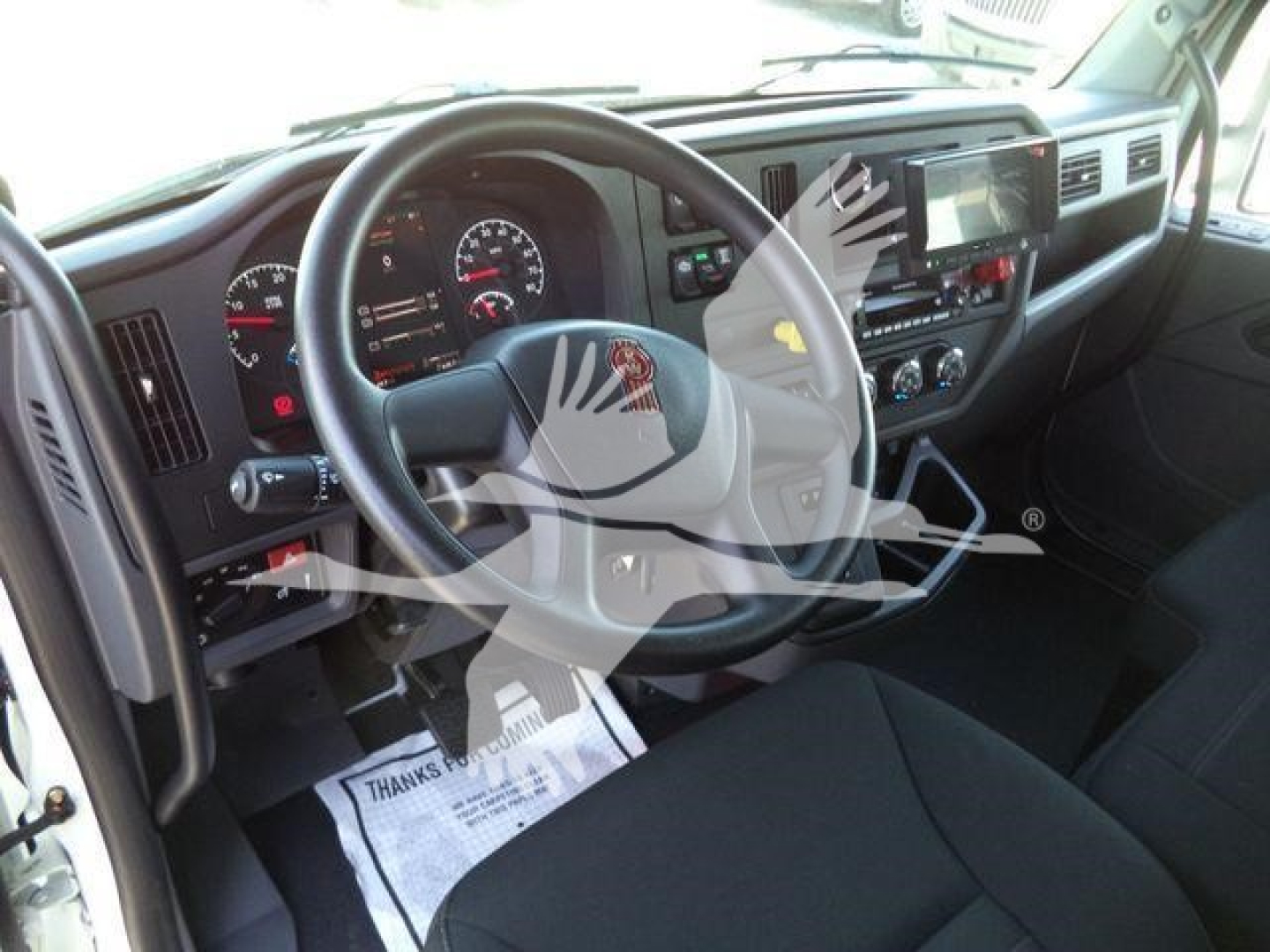 Kenworth T280 interior view showing steering wheel, dashboard gauges, and center console.