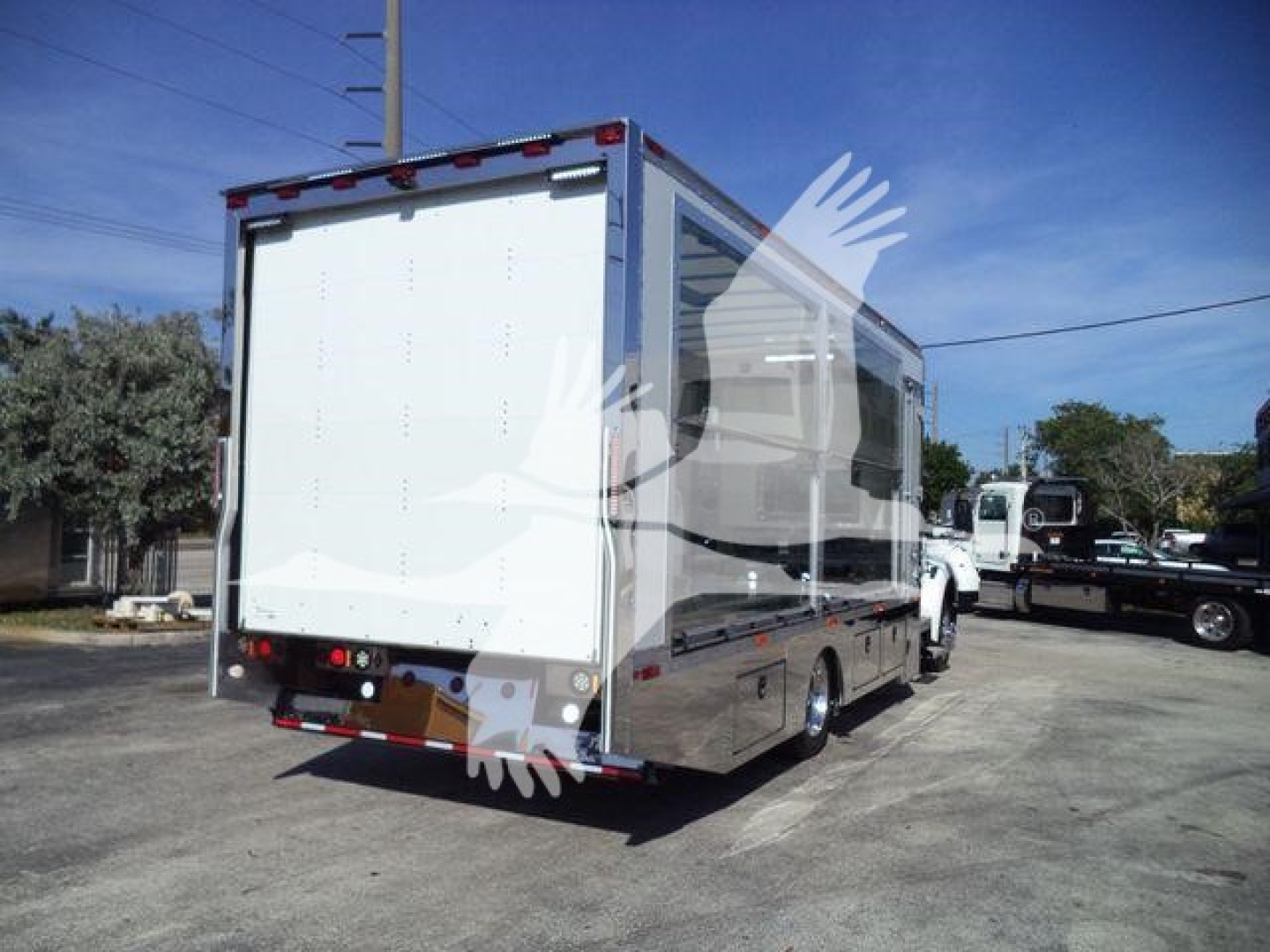Kenworth T280 rollback truck rear view showing cargo box and taillights.