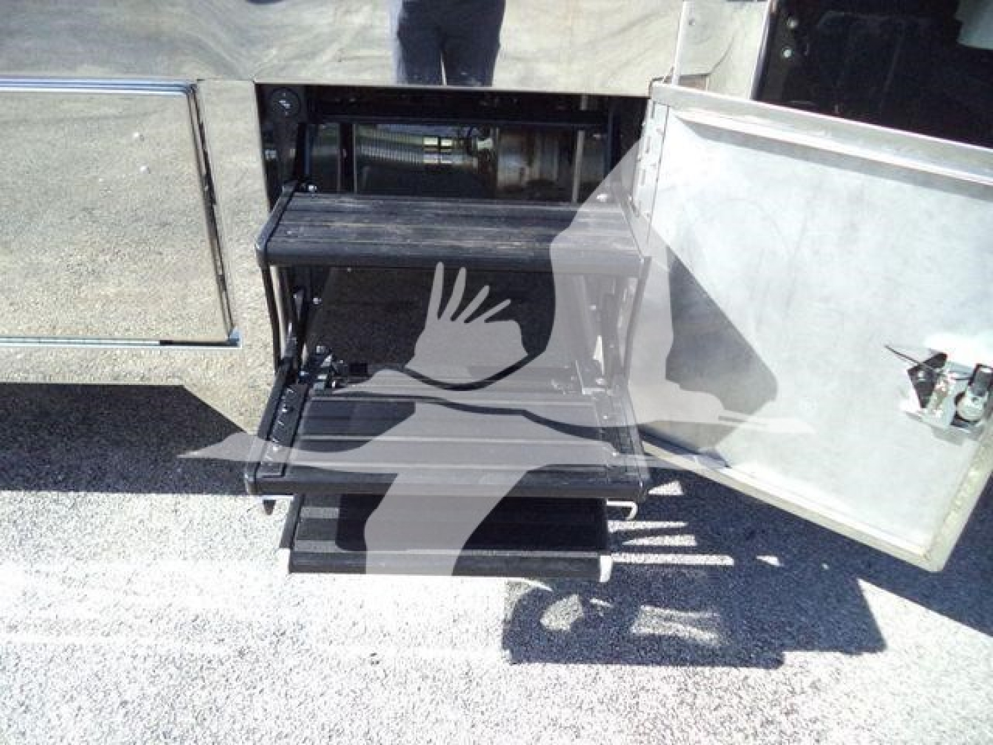Truck: Kenworth T280 rollback bed with under-bed storage and steps, open side door showing metal toolbox and loading platform.
