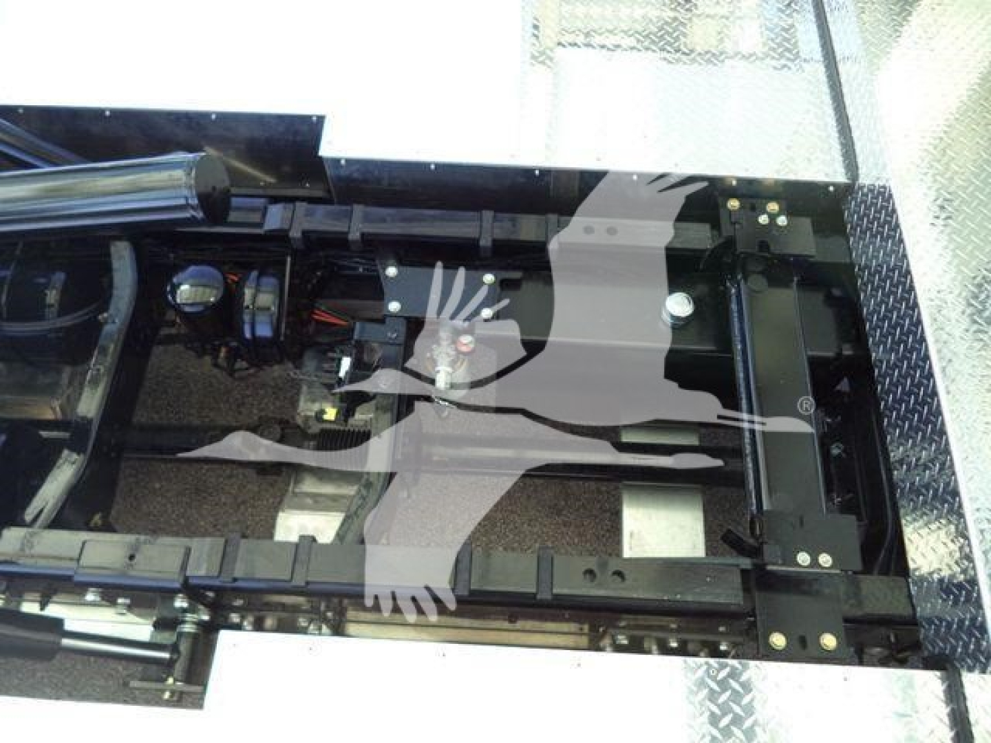 Kenworth T280 rollback truck chassis frame and mounting area visible, with hydraulic lines and suspension components.