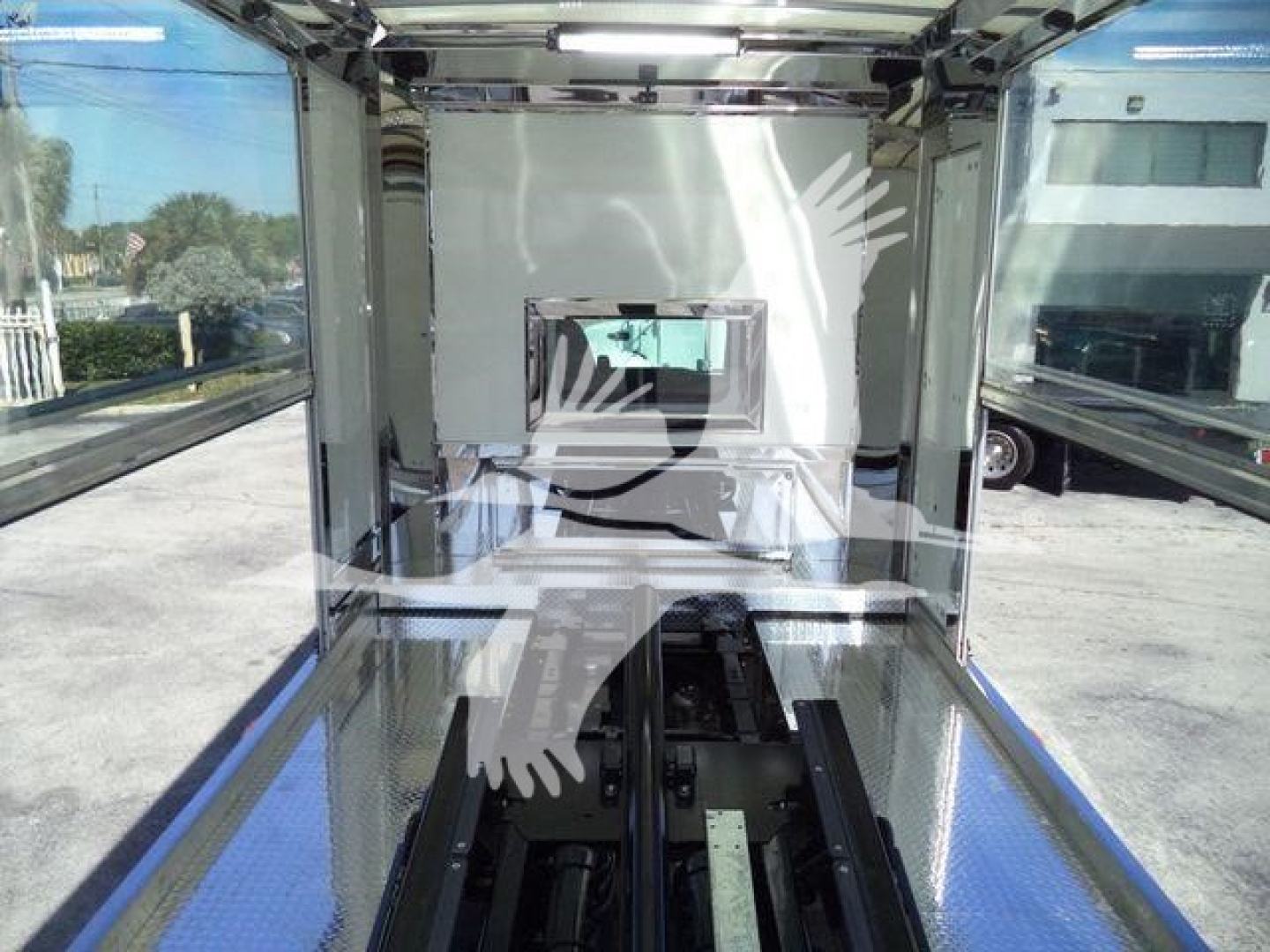 Kenworth T280 rollback truck cargo area interior with side walls and diamond plate floor, view toward cab area.