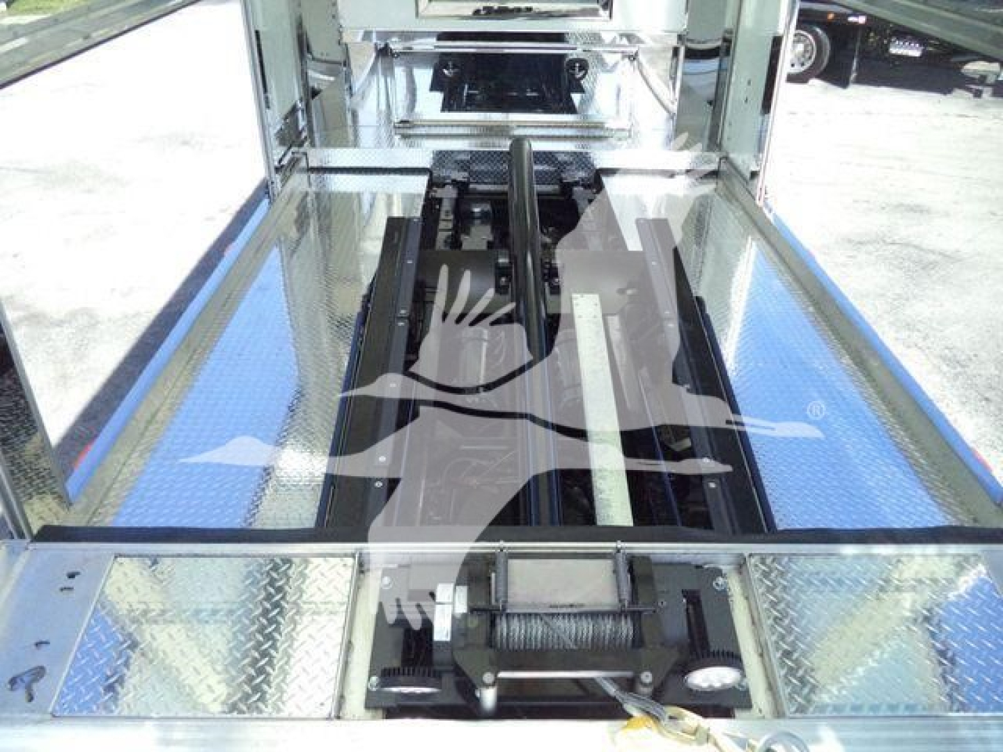 Kenworth T280 rollback truck interior showing hydraulic mechanism and reflective diamond plate floor.