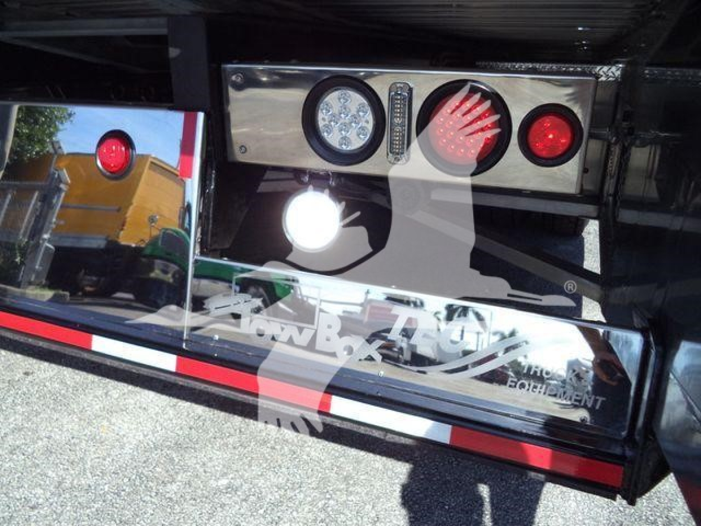 Kenworth T280 rollback truck rear with lights and chrome panel showing gauges and reflectors