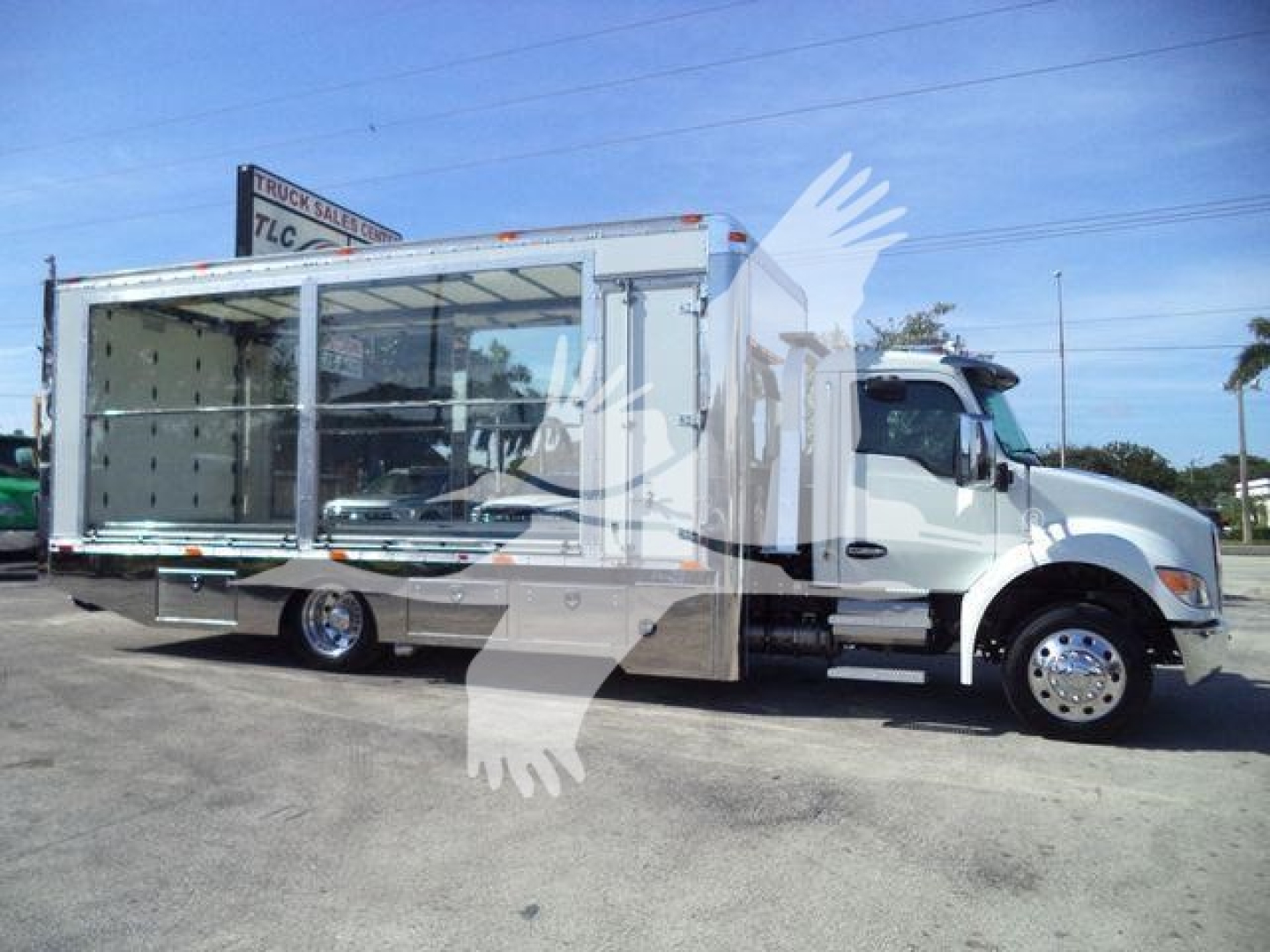 Kenworth T280 rollback truck with open cargo area side view showing cab and aluminum cargo body.