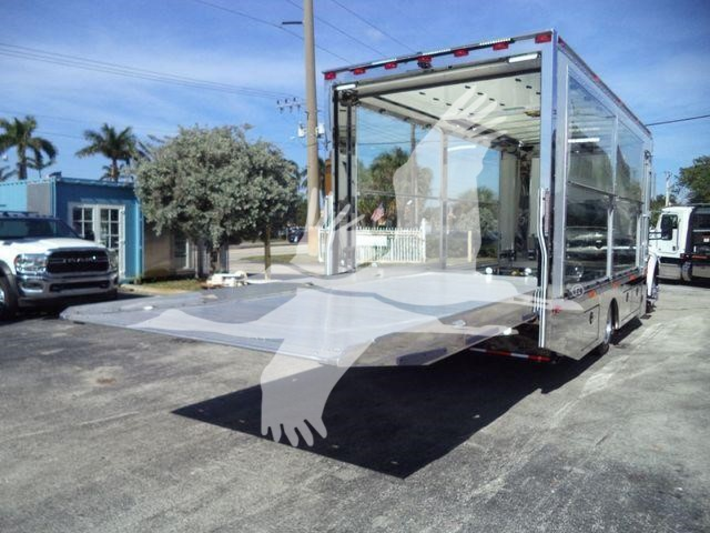 Kenworth T280 rollback truck with clear glass rear and sides, empty cargo area, outdoor lot, stock #J40656FM.