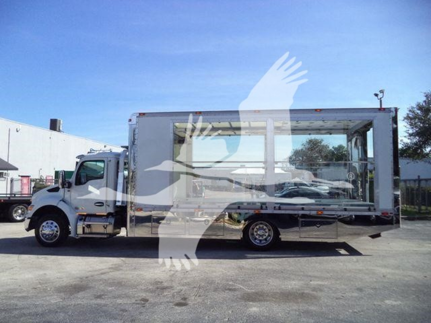 Kenworth T280 rollback truck in side view showing aluminum box body with large side window and wheels; stock label J40656FM, new unit.