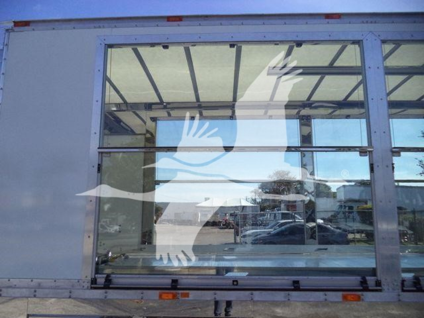 Truck equipment image showing a large rear window with a white graphic of a bird in flight overlayed on glass.