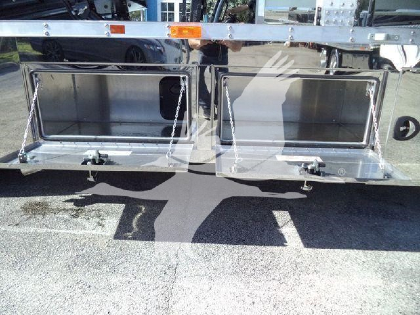 Kenworth T280 rollback truck underneath showing two open storage compartments or tool boxes in the rear area.